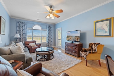 Living area featuring a ceiling fan, baseboards, l