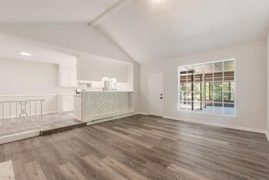 Unfurnished living room featuring beam ceiling, da