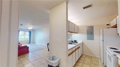Kitchen featuring light tile patterned flooring, c