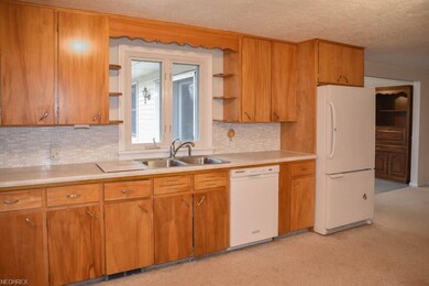 The kitchen has beautiful tile backsplash.
