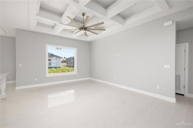 Spare room with visible vents, ceiling fan, coffered ceiling, and baseboards