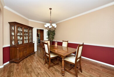 The formal dining is spacious and is adjacent to the kitchen for ease of serving. Two tone custom paint, crown molding and chair rail make the room warm and inviting.