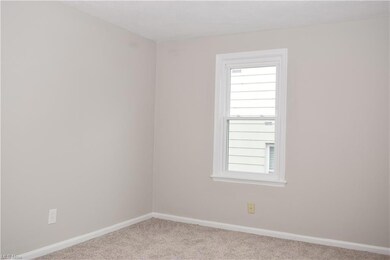 Carpeted spare room featuring plenty of natural li