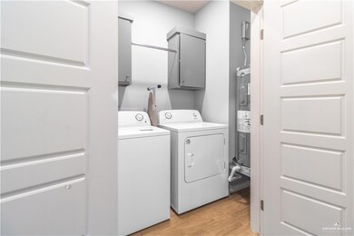 Laundry area with cabinet space, independent washer and dryer, and water heater