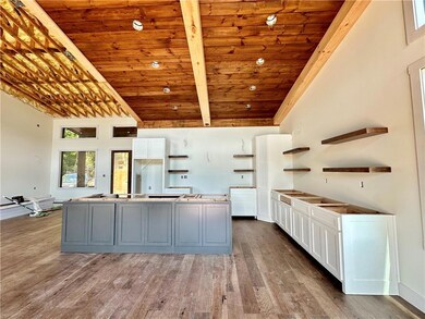 Kitchen with 8 Ft Island with Quartz Countertops & Matching Quartz backsplash *Images shown are for visual representation of a different home site, but SAME floor plan. *
