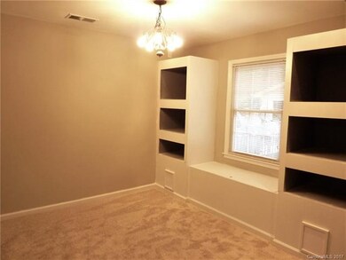 Dining room has built in display shelves and bench