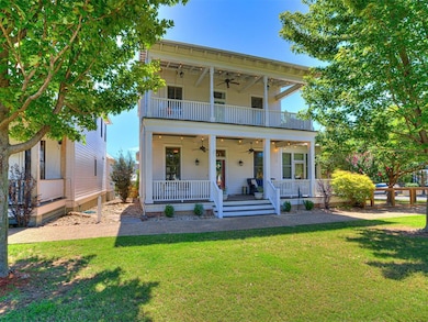 View of front of house with a front yard, a balcon