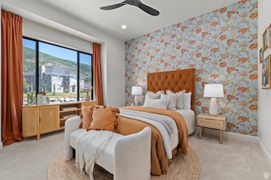 Bedroom featuring wallpapered walls, light colored carpet, an accent wall, a ceiling fan, and recessed lighting