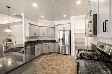 Kitchen with a sink, stainless steel appliances, d