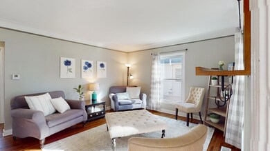 Light and bright Living Room with enameled woodwork and beautiful hardwood floors.