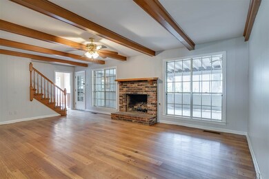 Spacious den. Fireplace and lots of light.