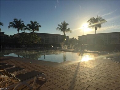 Pool at dusk featuring a water view