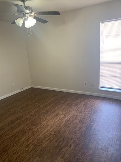 Empty room featuring ceiling fan, baseboards, and