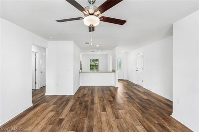 Unfurnished living room with ceiling fan and dark