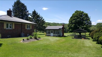 Back yard with playhouse or man-cave (basement) and picnic pavilion.