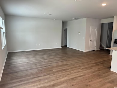 Unfurnished room featuring wood finished floors, v