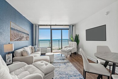 Living room featuring a wall mounted AC, hardwood 