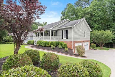 Ranch-style home featuring covered porch, an attached garage, a front yard, driveway, and a chimney
