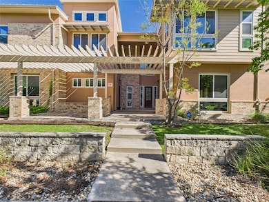 View of front of house with a pergola, brick sidi