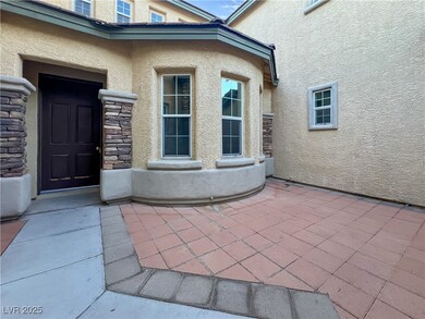 View of exterior entry featuring stone siding, a p