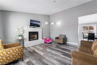 Living area featuring a fireplace, vaulted ceiling