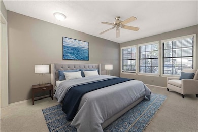 Bedroom featuring baseboards, light carpet, and a