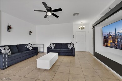 Living room featuring ceiling fan with notable cha