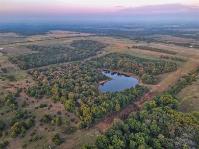 Aerial view at dusk featuring a water view