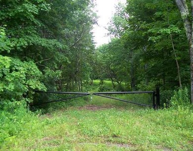 Exterior Front. Gate to road into...