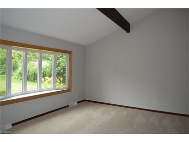 Spacious living room with cathedral beamed ceiling