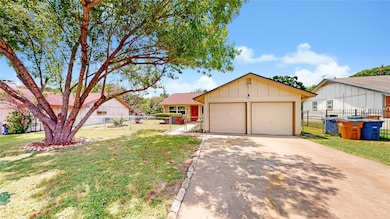 Ranch-style house featuring concrete driveway, bo