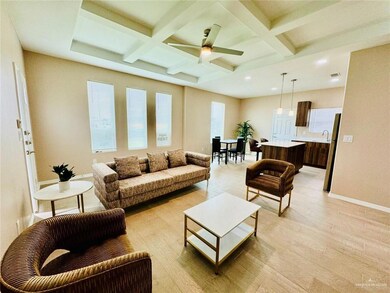 Living room featuring coffered ceiling, beam ceiling, light wood-type flooring, and a ceiling fan