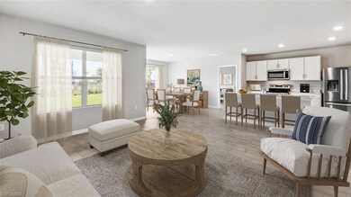 Living area with light wood finished floors, recessed lighting, and baseboards