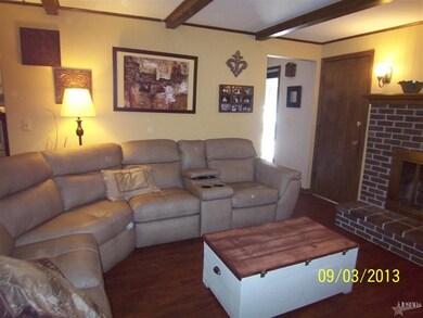 Beamed living room with fireplace and built ins