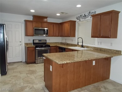 Kitchen with stainless steel appliances, a peninsu