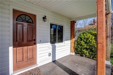 The covered front porch is a great place to enjoy the nice weather or relax with a cup of coffee.