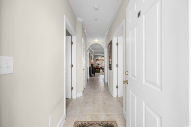 Hall featuring light tile patterned floors