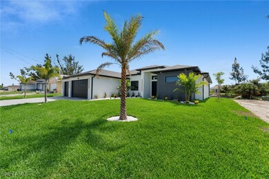 View of front of property featuring a garage, driv