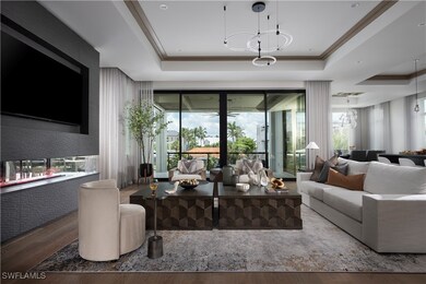 Living room with a tray ceiling and wood finished
