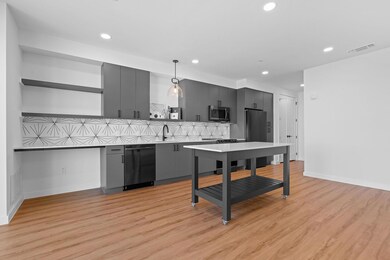Kitchen with modern cabinets, decorative backsplash, light wood-type flooring, recessed lighting, and open shelves