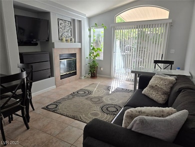 Tiled living room with a tiled fireplace and vault