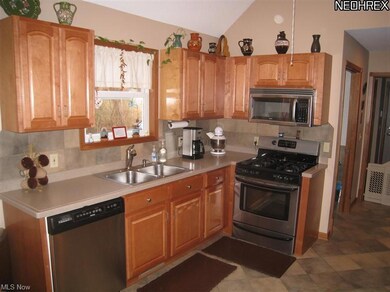 Kitchen with maple cabinets and ceramic tile.