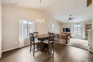 Dining space featuring vaulted ceiling, ceiling fa