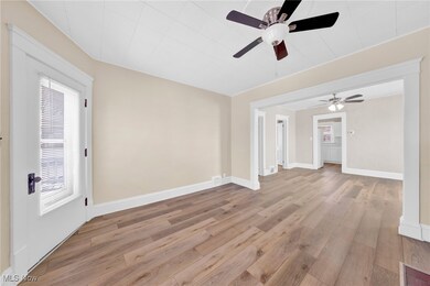 Virtually Staged Empty room featuring baseboards, a ceiling fan, and light wood finished floors
