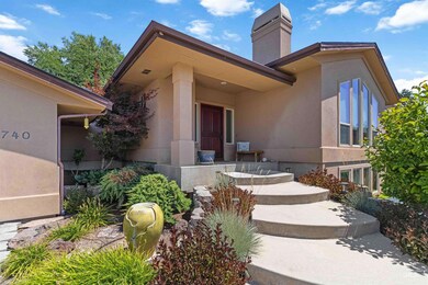 Entrance to property with stucco siding and a chimney