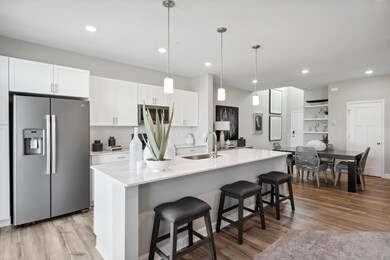 Open concept, the home's kitchen space is highly desirable and features a large kitchen island serving as the perfect centerpiece for cooking and entertaining! *Photos of model home; colors and finishes will vary.