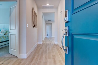 Corridor featuring light wood-type flooring and ba