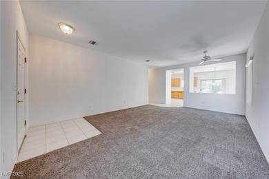 Unfurnished living room featuring light carpet, ce
