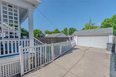 View of side of home with an outbuilding and a garage