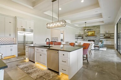 Kitchen featuring a fireplace, stainless steel app